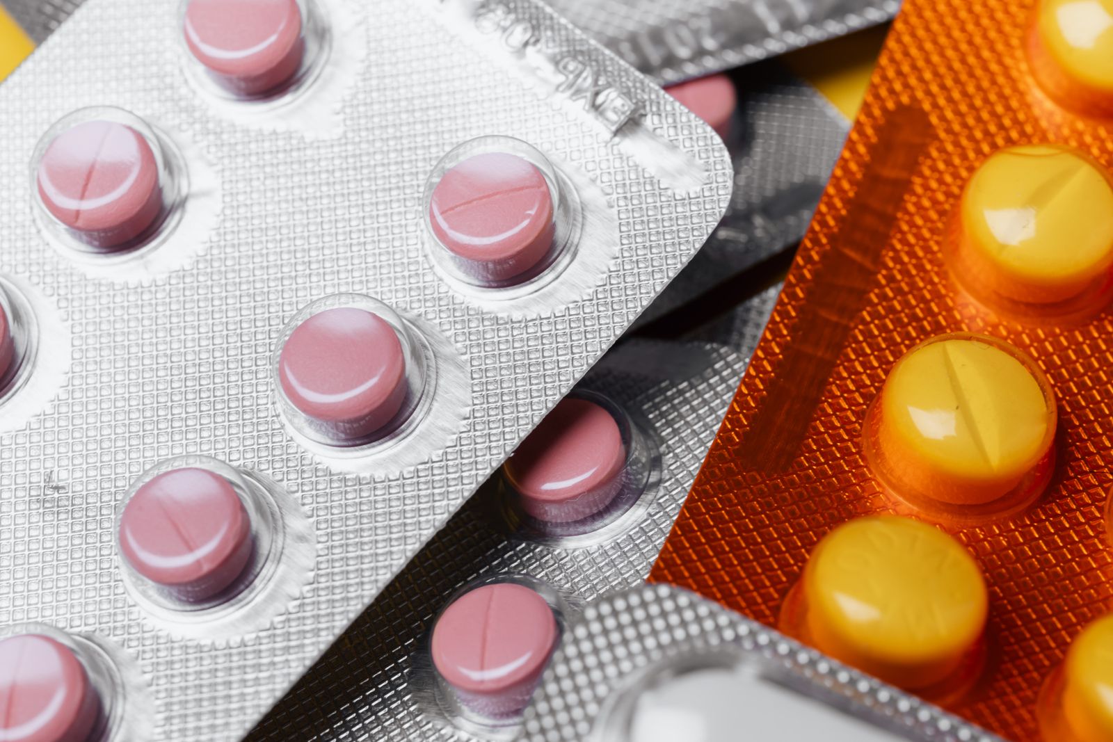 Pharmaceutical blister packs with heat-sealed foil backing