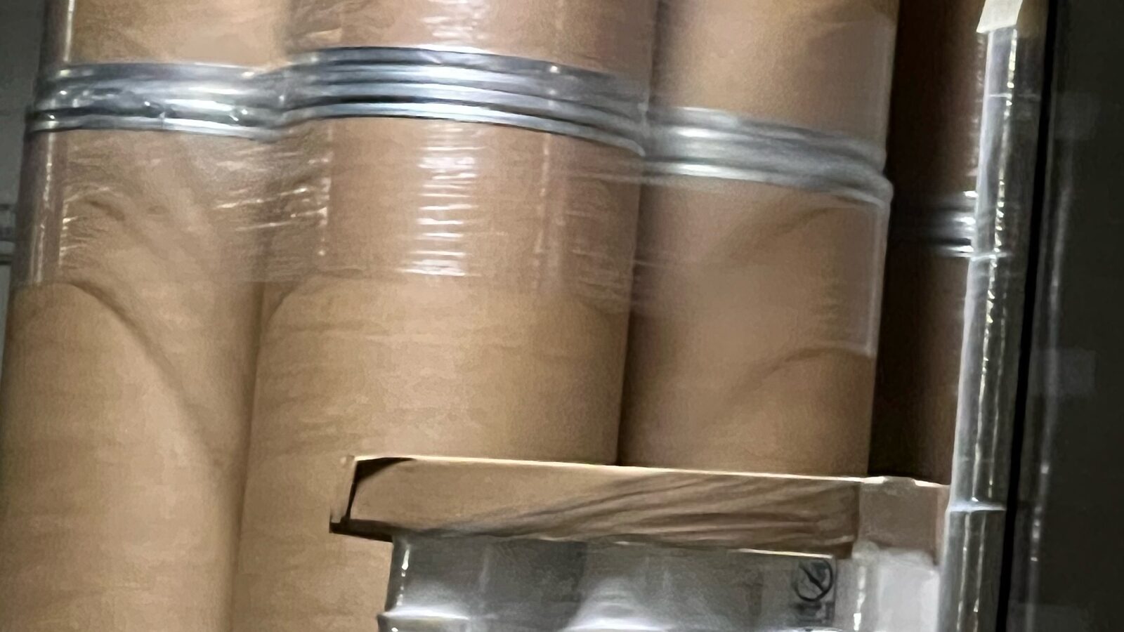 Kraft fiber drums and white pails wrapped for shipment