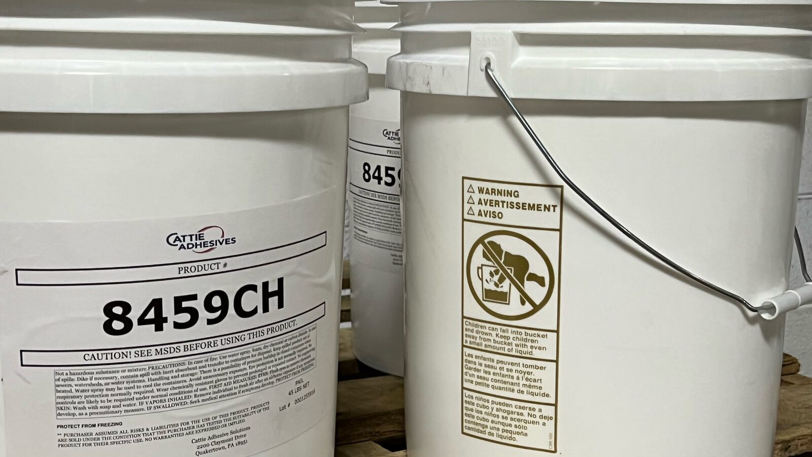 White Cattie Adhesives pails labeled 8459CH on a pallet