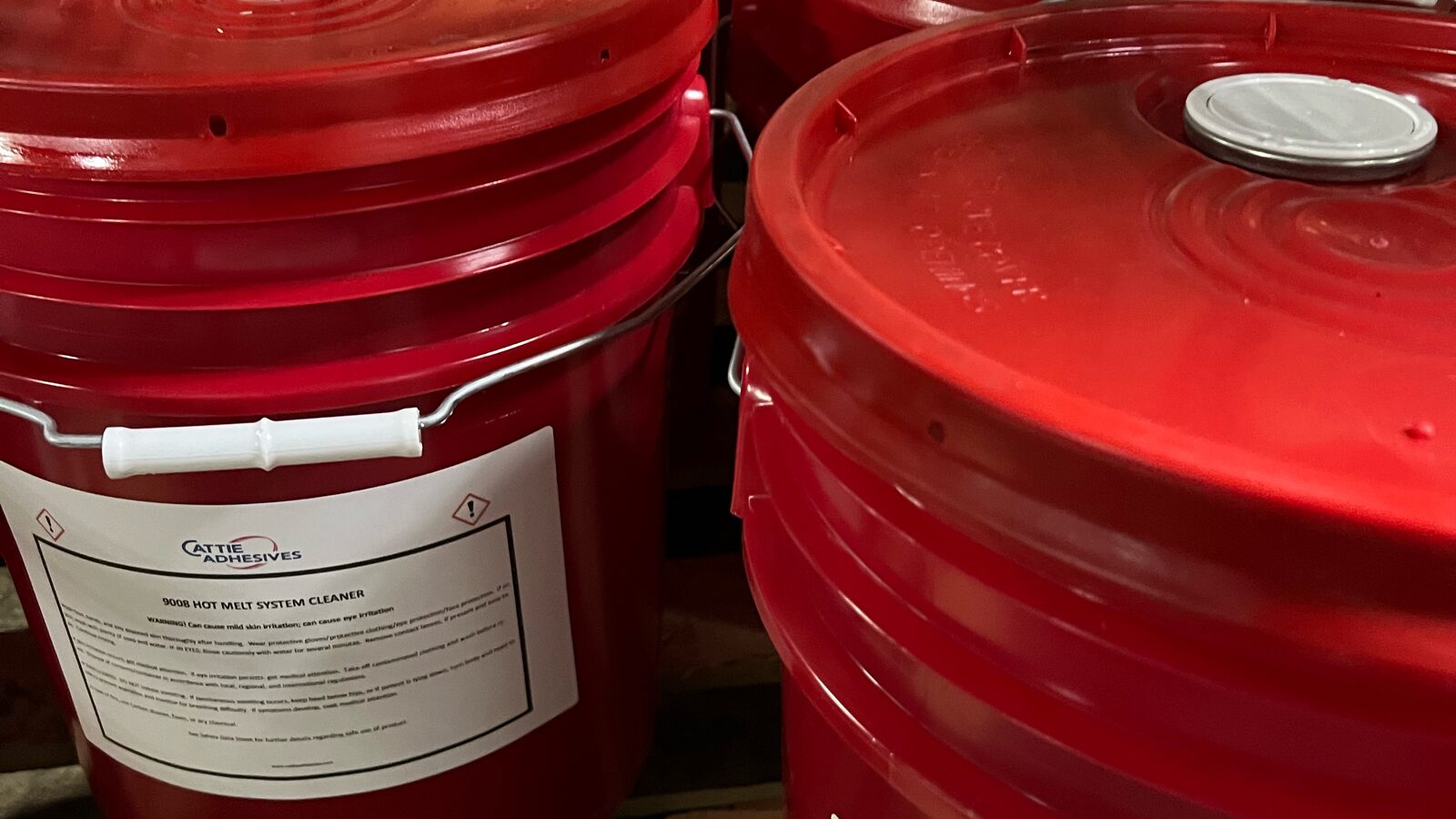 Red Cattie Adhesives pails of 9008 hot melt system cleaner