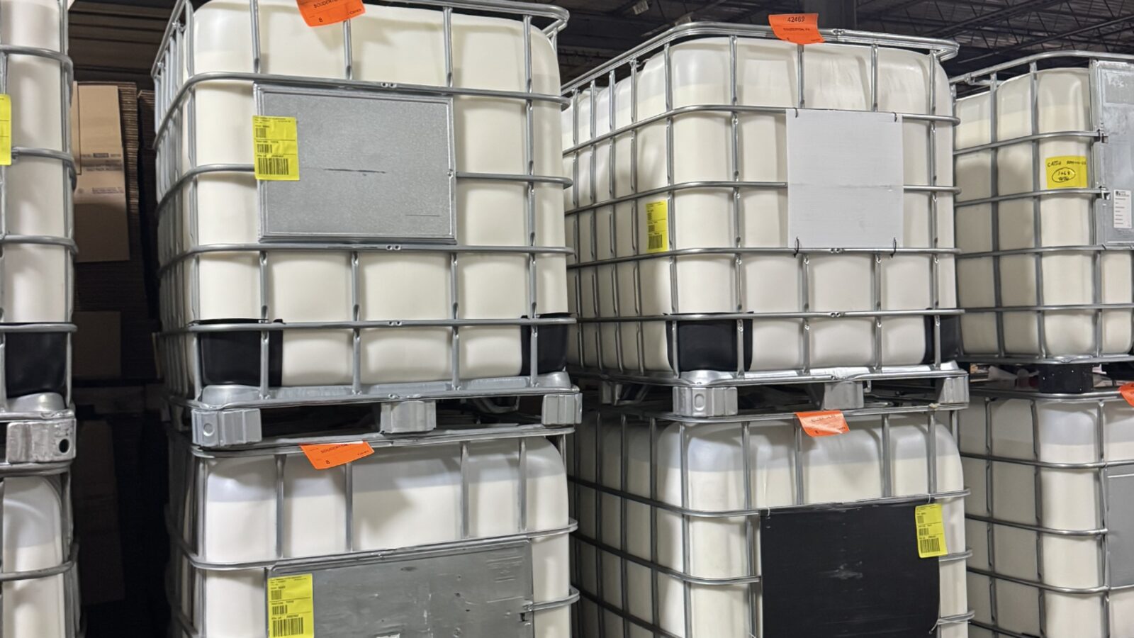 Row of filled IBC totes in the Cattie Adhesives warehouse