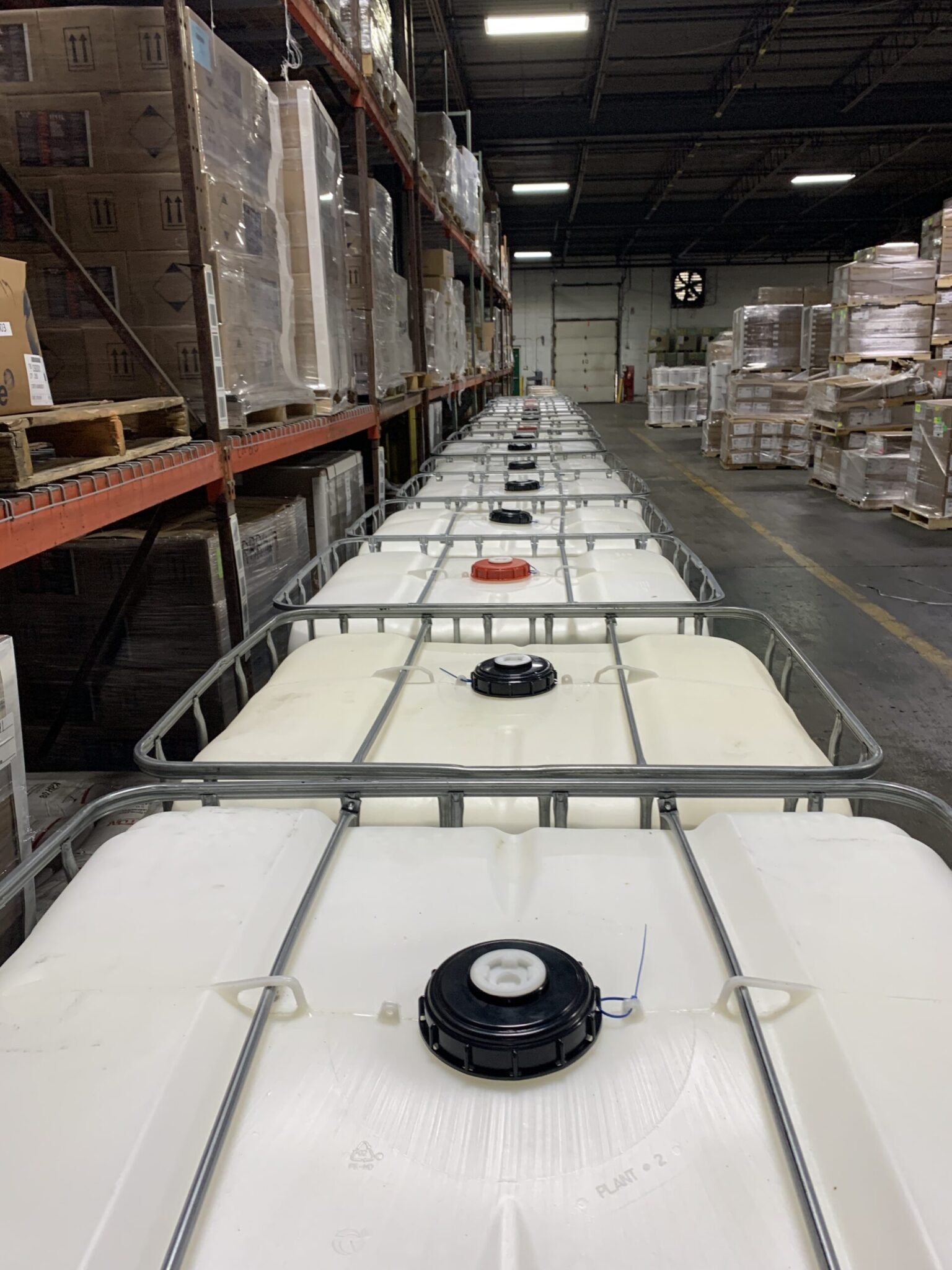 White IBC totes of liquid adhesive in a row at the Cattie plant