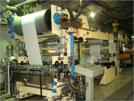 Industrial hot-melt coater applying adhesive to a continuous web