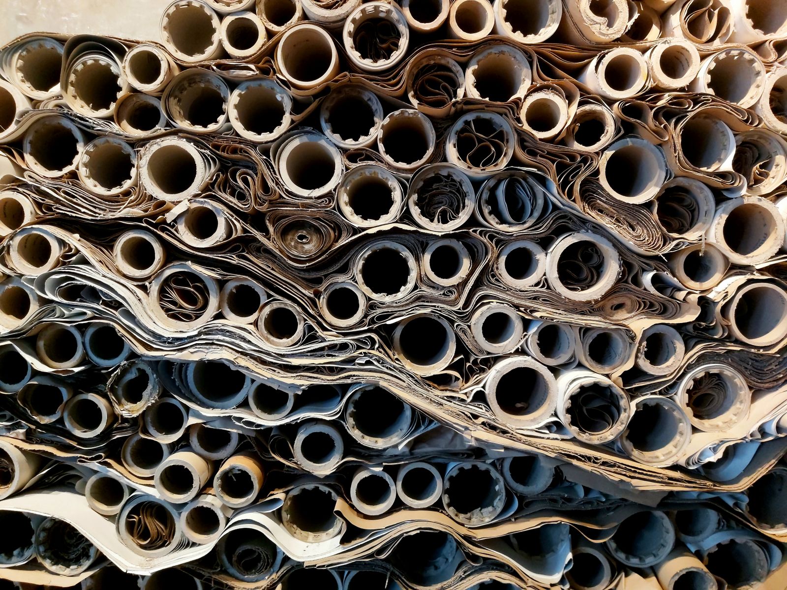 Stacks of rolled paper tubes