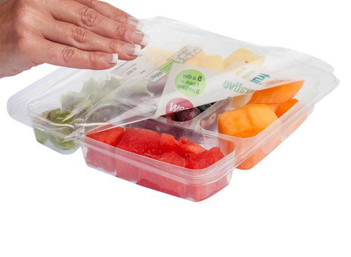 Multi-compartment fruit tray with peel-and-reseal film lid being opened